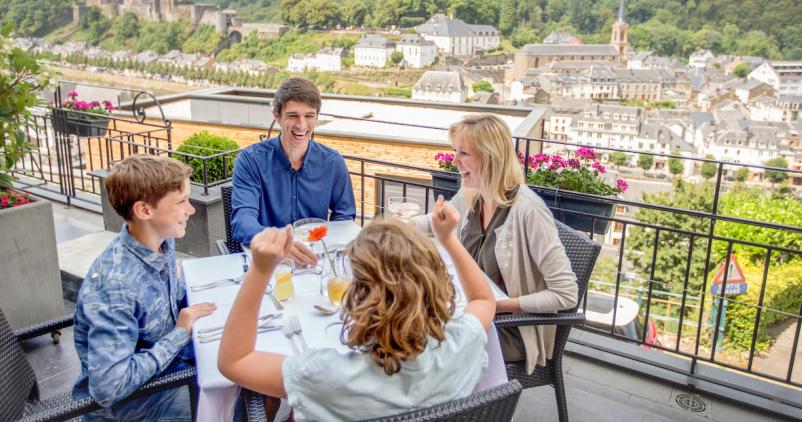 Quatre personnes attablées en terrasse